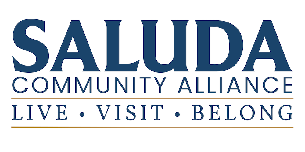 Logo for Saluda Community Alliance: large 'SALUDA' with 'COMMUNITY ALLIANCE' subtitle and 'LIVE • VISIT • BELONG' beneath with gold lines.